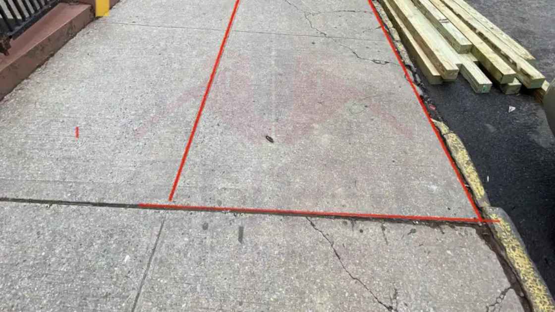 Repairing damaged and cracked sidewalks.